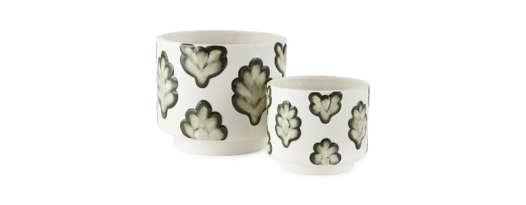 Two ceramic planters with green leaf print