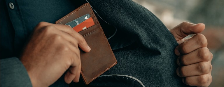 Man putting away his credit card wallet