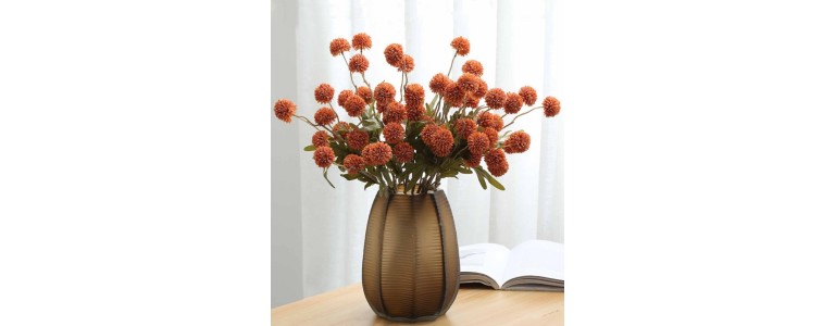 A vase of artificial fall-colored flowers