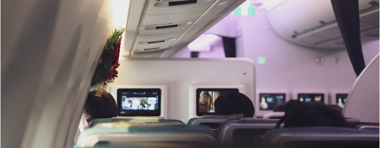 Passengers on plane with Christmas wreath on the window